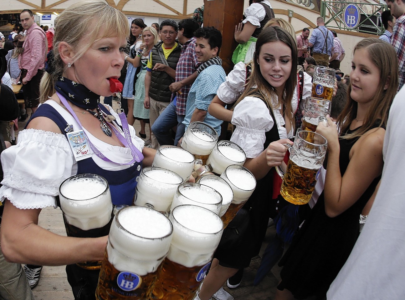 A waitress carries 10 beer mugs.