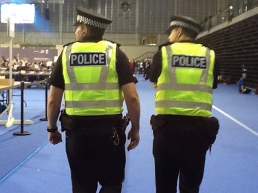 Police officers patrol the Emirates Arena in Glasgow as votes are counted