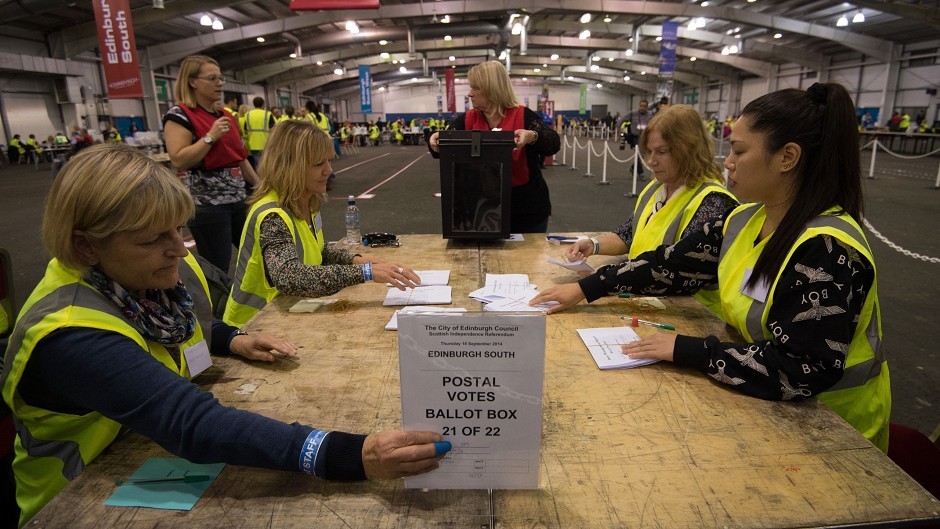 Volunteers begin to count the first postal ballots returned for the Scottish referendum at Highland Hall in Ingliston