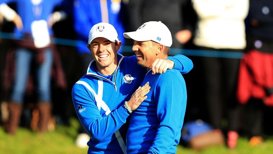 Sergio Garcia, right, celebrates after chipping in from a bunker with playing partner Rory McIlroy