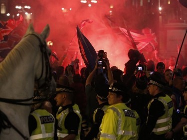 Police stand in front of Unionists gathered in George Square, Glasgow, following the Scottish independence referendum.