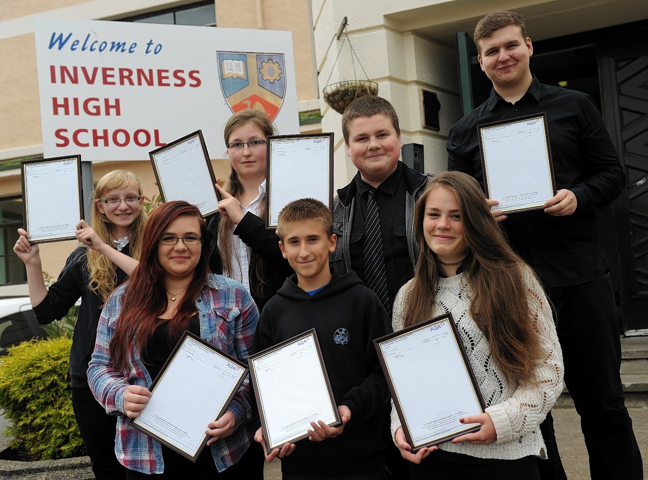 Polish students show off their results outside Inverness High School