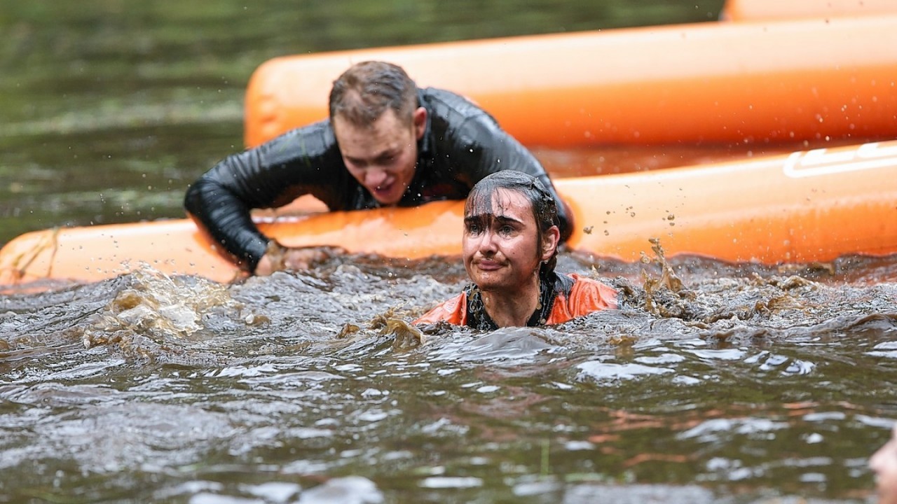 Competitors navigate the boggy pond in the inaugural Beast Loch Ness 10K obstacle race at Aldourie.