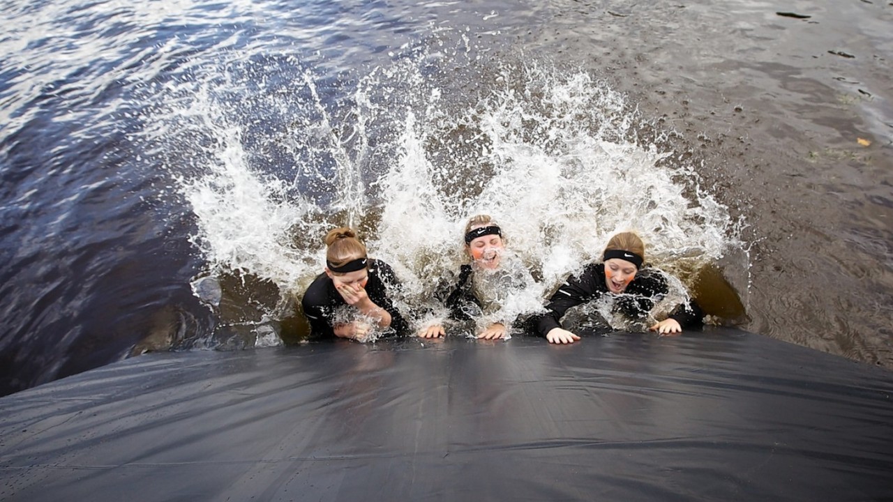 Competitors navigate the boggy pond in the inaugural Beast Loch Ness 10K obstacle race at Aldourie.