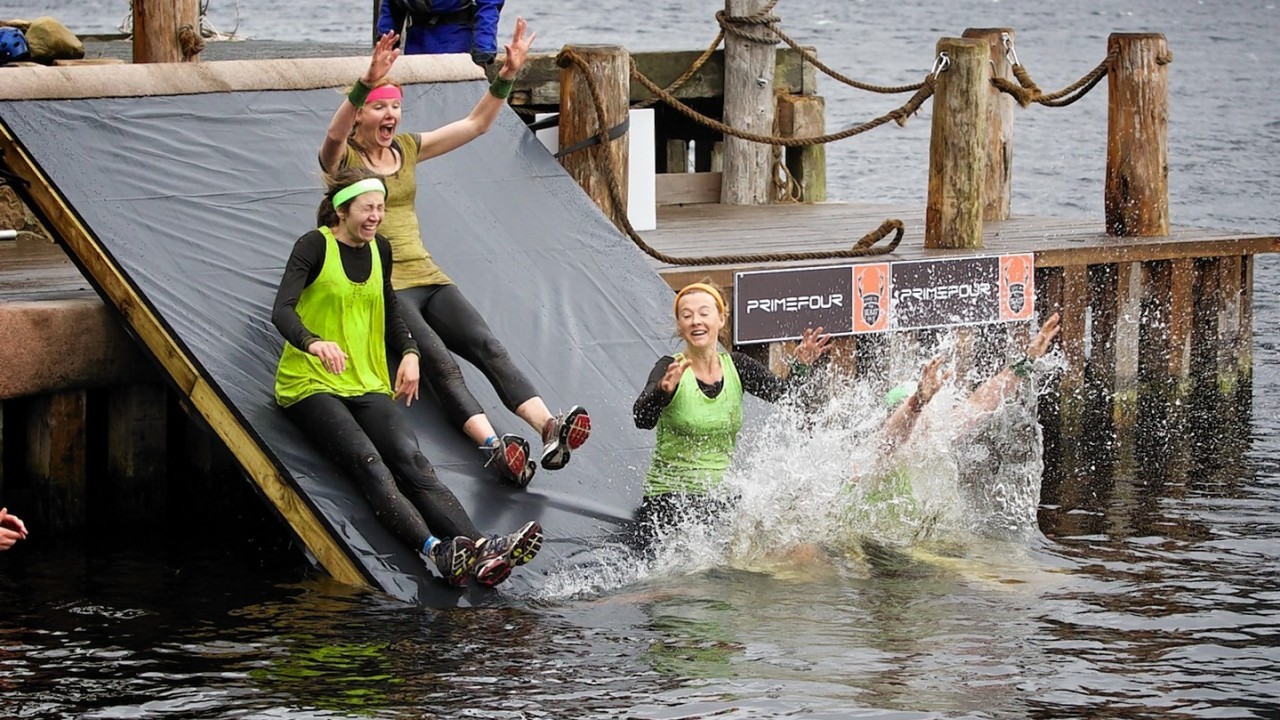 Competitors navigate the boggy pond in the inaugural Beast Loch Ness 10K obstacle race at Aldourie.