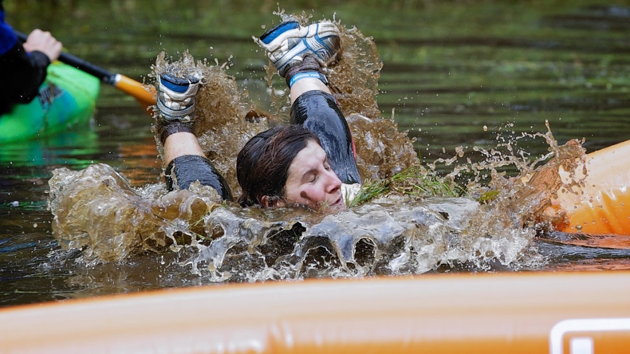 Competitors navigate the boggy pond in the inaugural Beast Loch Ness 10K obstacle race at Aldourie.