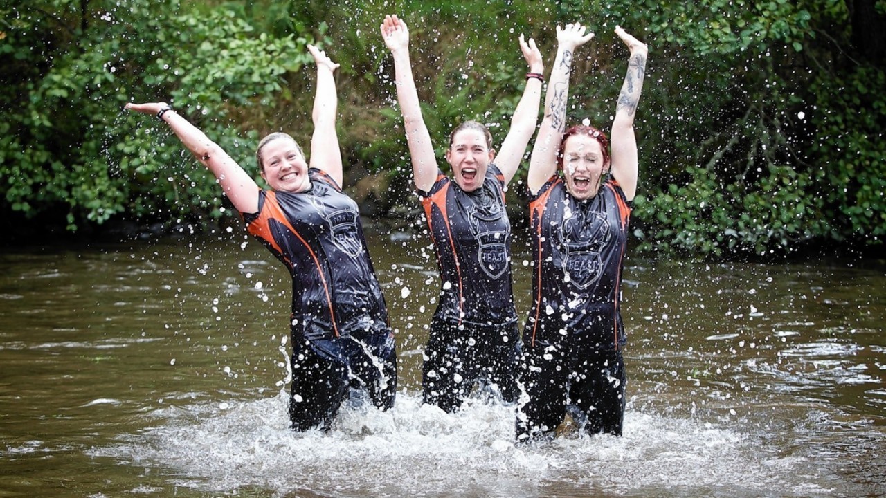 Competitors navigate the boggy pond in the inaugural Beast Loch Ness 10K obstacle race at Aldourie.