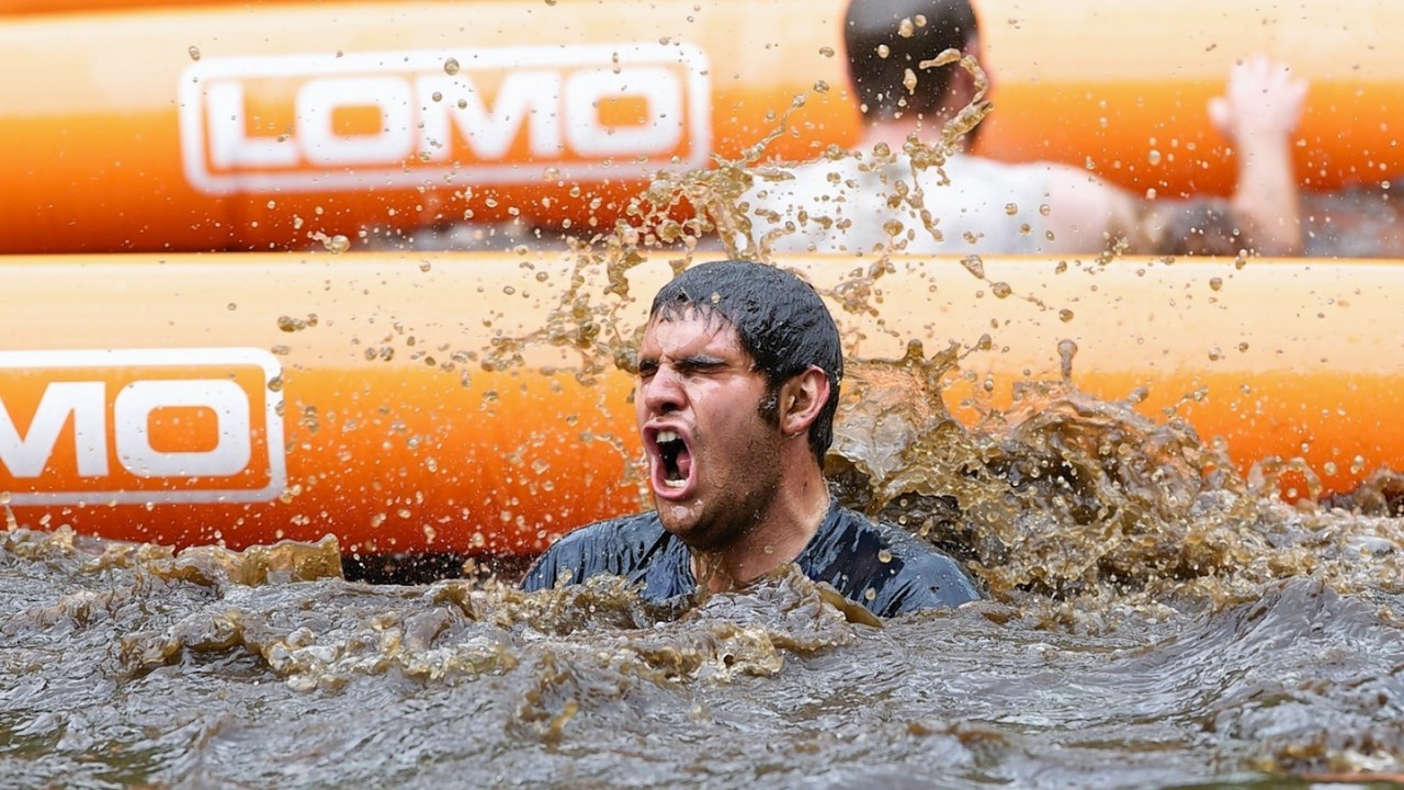 Competitors navigate the boggy pond in the inaugural Beast Loch Ness 10K obstacle race at Aldourie.