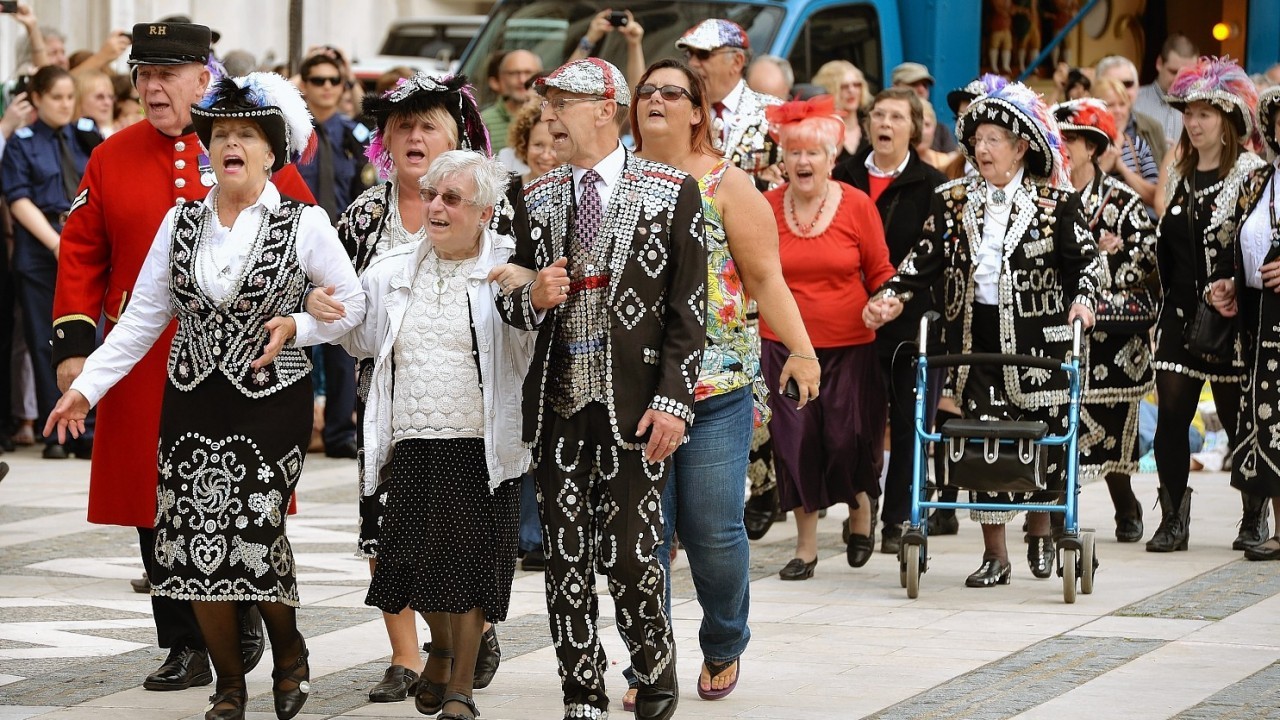 The Pearly Kings and Queens gather at the Guildhall Square as they parade to St Mary-le-Bow church to celebrate the harvest festival