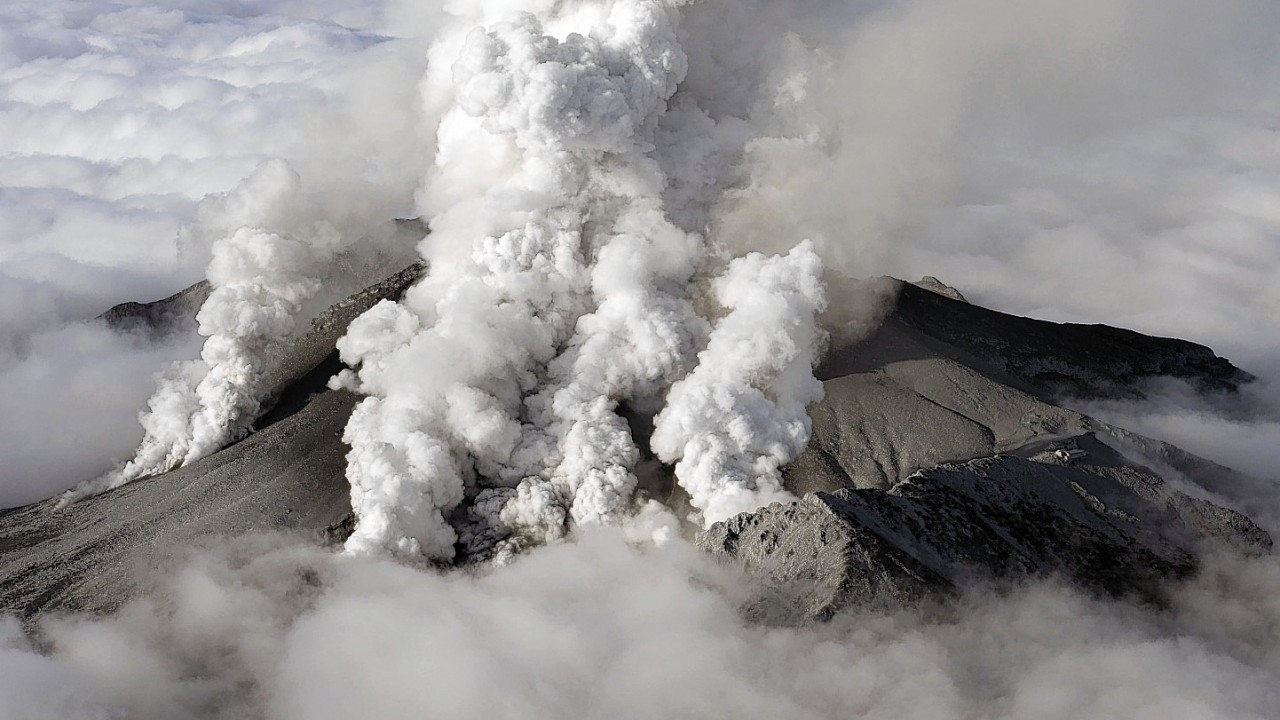 Plumes of smoke and ash billow from Mount Ontake as it continues to erupt in central Japan, Sunday, Sept. 28, 2014