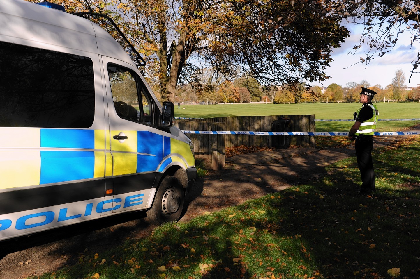 Police stand guard at Cooper Park, Elgin.