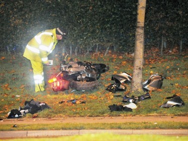 A police officer investigates the shattered Kawasaki following the crash near Altens