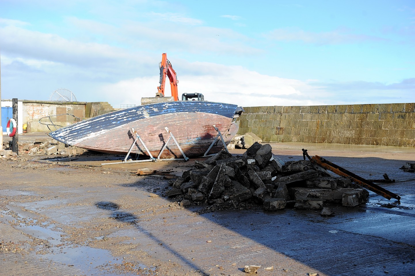 The flooding clean up begins at Lossiemouth where a boat was knocked over by the waves