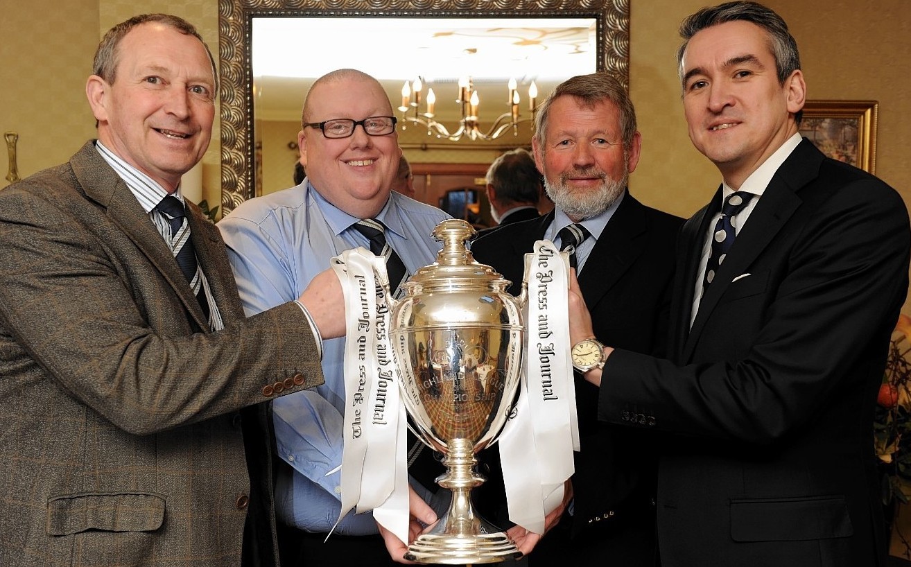 Willie Lippe, Finlay Noble, John Grant and Press and Journal Editor-in-Chief Damian Bates show off the Highland League trophy