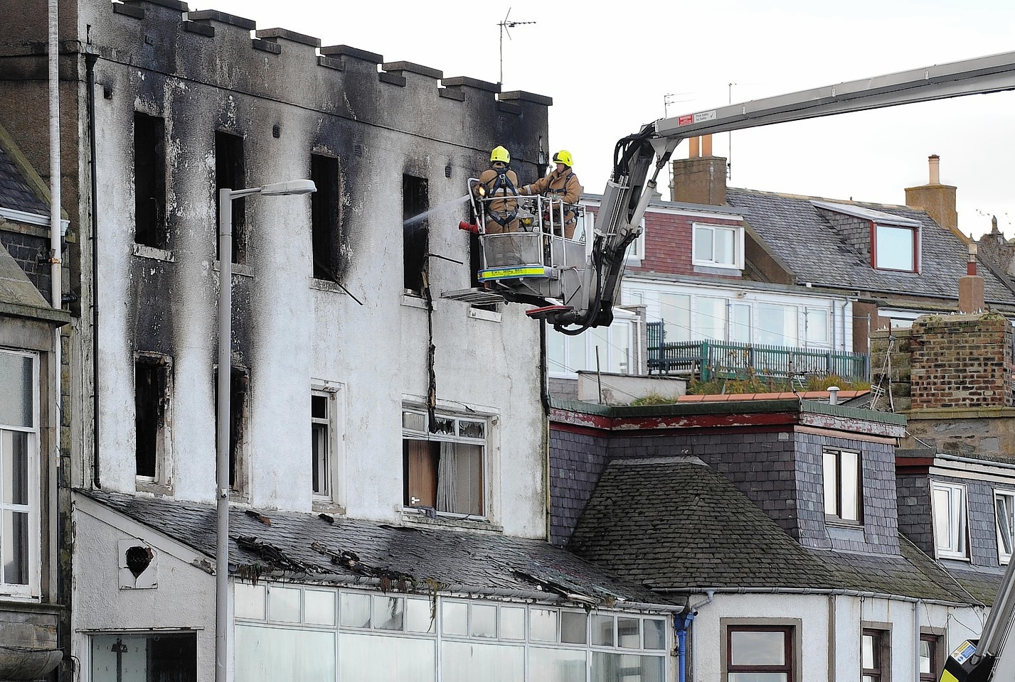 Fire crews work to make the building safe