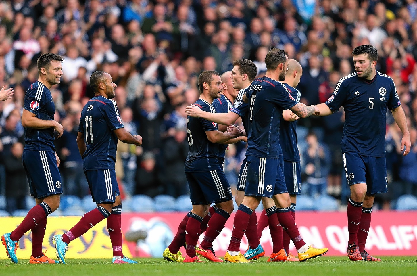 The Scotland players celebrate with Shaun Maloney after his shot resulted in the only goal of the game