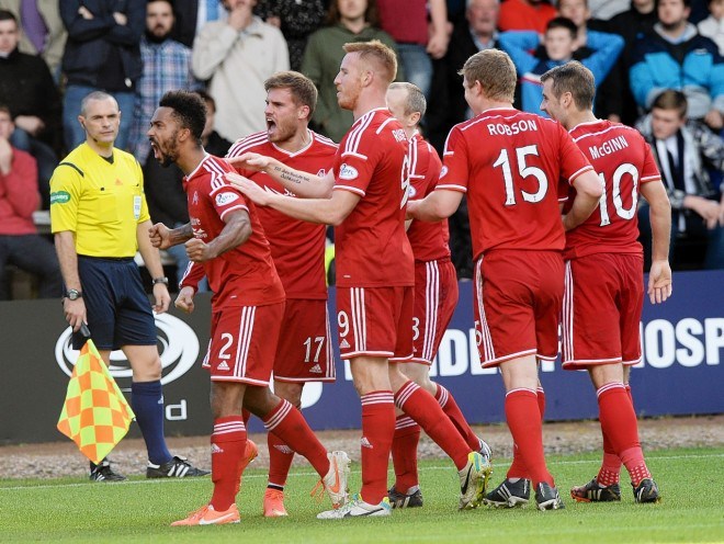 Dons players celebrate Goodwillie's winner