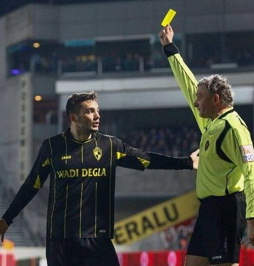 Tony Watt picks up a booking while playing for Lierse