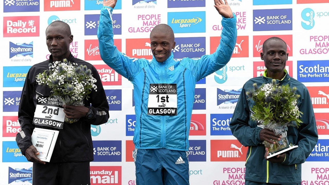 South African runner Stephen Mokoka (centre) celebrates his win in the half marathon with second place Stephen Chemlany and third place Mark Kiptoo (right)