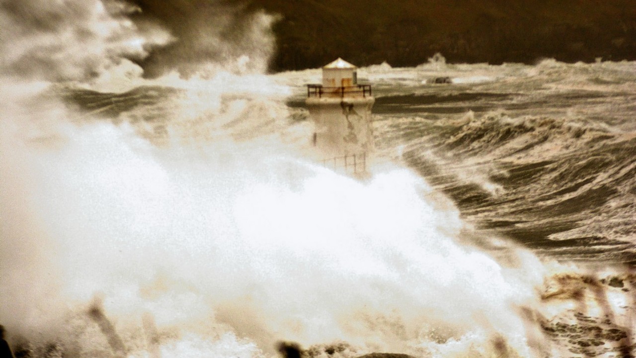 Waves engulf a lighthouse in Wick yesterday