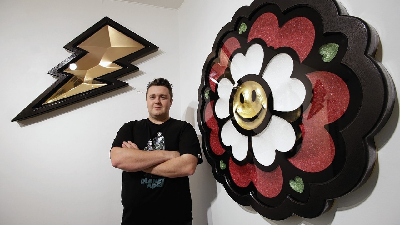 Artist Ryan Callanan poses next to his pieces Tudor (right) and Power, during a preview for his exhibition 8 Forever, at Lawrence Alkin Gallery in London.