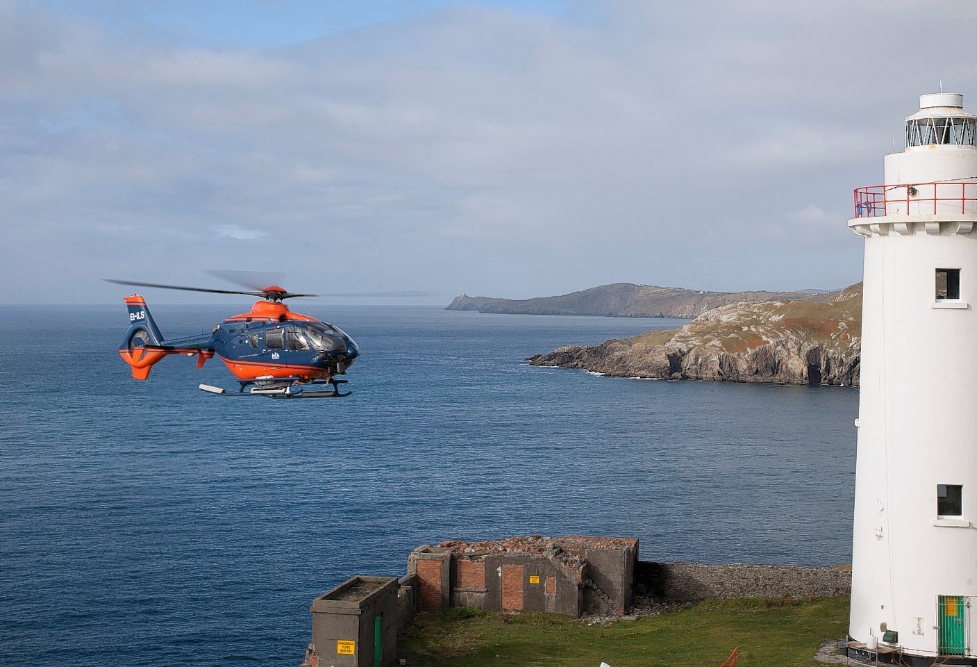 One of PDG's EC 135 helicopters carries out work at Ardnakinna Lighthouse in Ireland