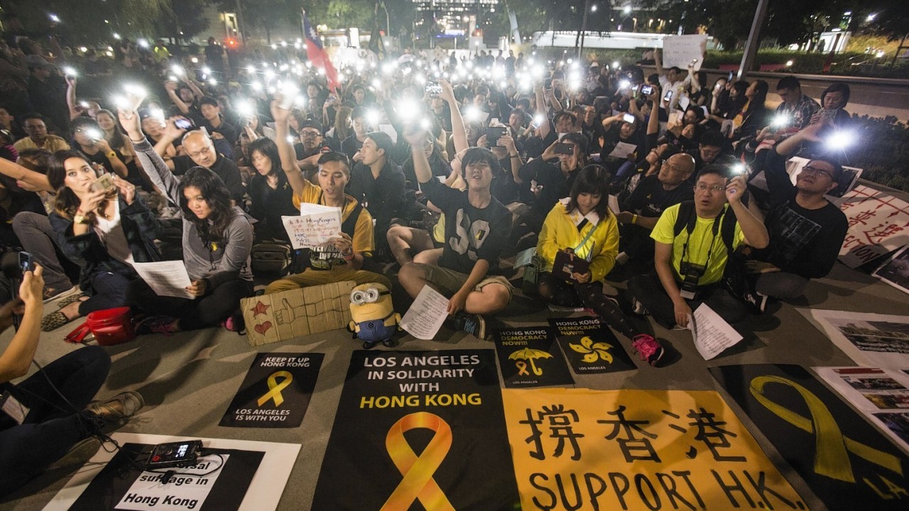 Hundreds of demonstrators wave with their mobile phones at Grand Park downtown Los Angeles to show their support for the pro-democracy protesters in Hong Kong