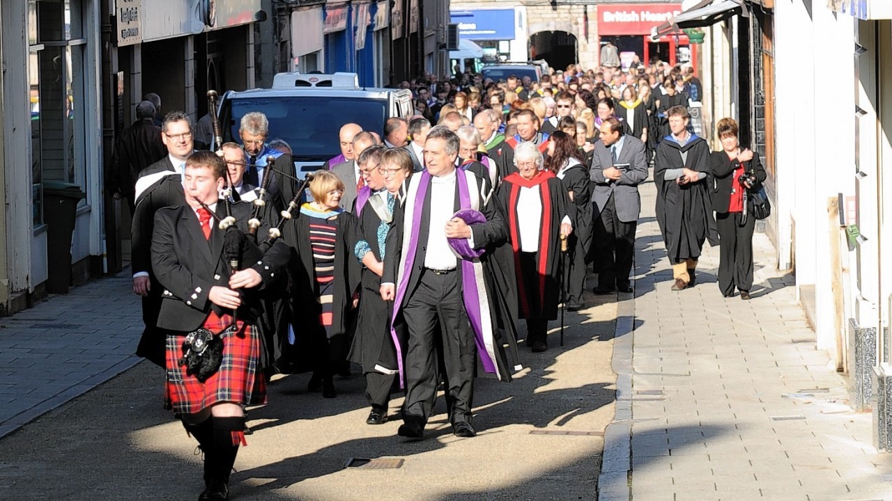 Graduates parade from St. Giles Church, High Street, Elgin, to the college after the ceremony