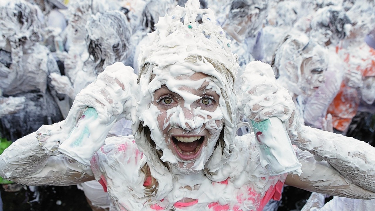 St Andrews University students take part in a foam fight known as Raisin Monday following the Raisin Weekend, an annual tradition where student "parents" inflict tasks on the unfortunate first-years