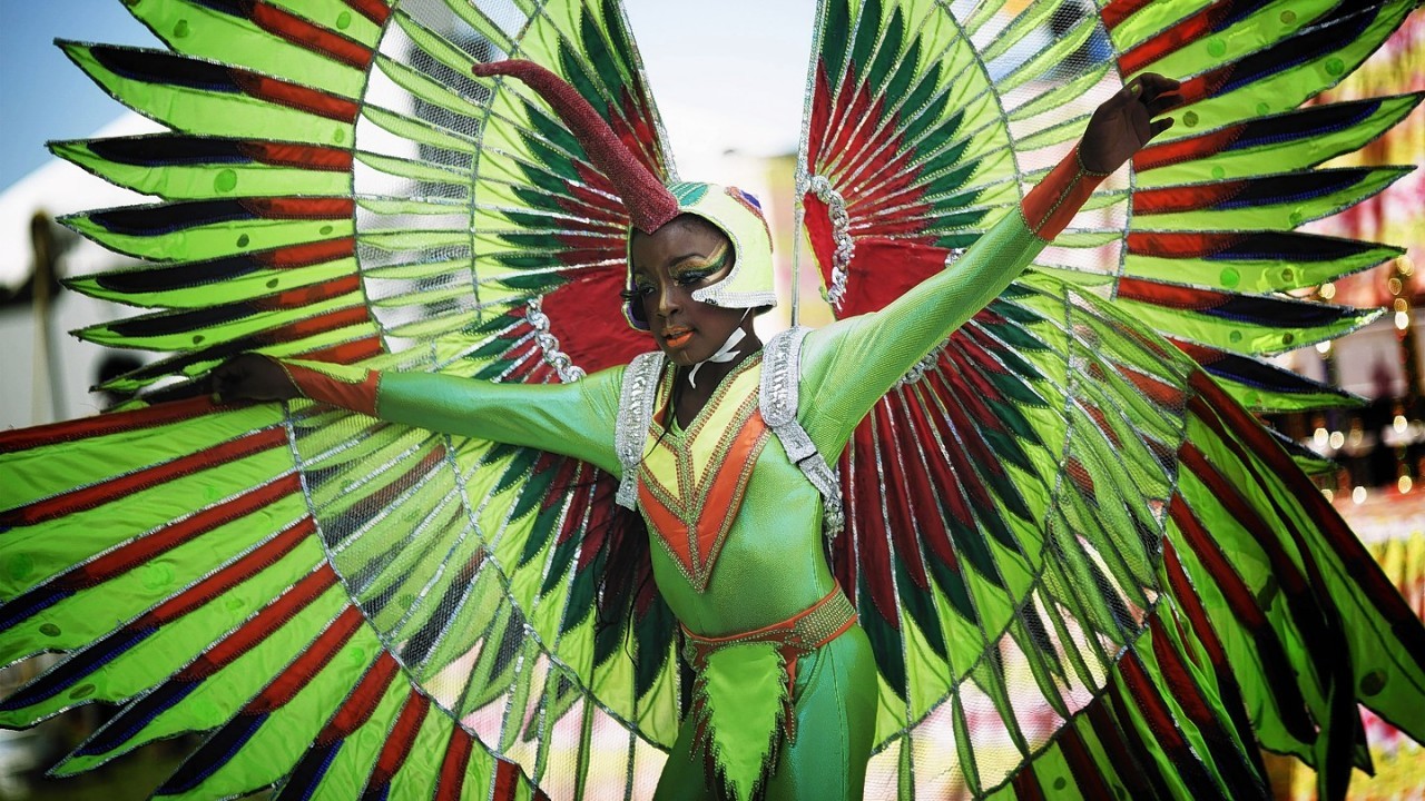Kilah Foster, dressed as the Bird of Paradise, dances for the judges at the Miami Broward Junior Carnival parade, Sunday, Oct. 5, 2014, in Lauderhill, Florida
