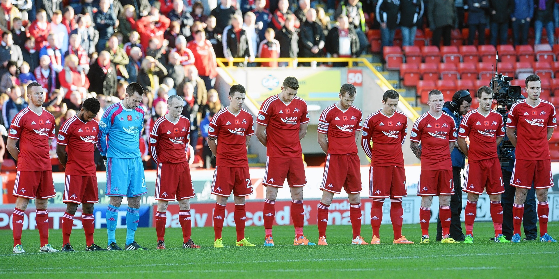 Aberdeen players observe the minute silence at Pittodrie