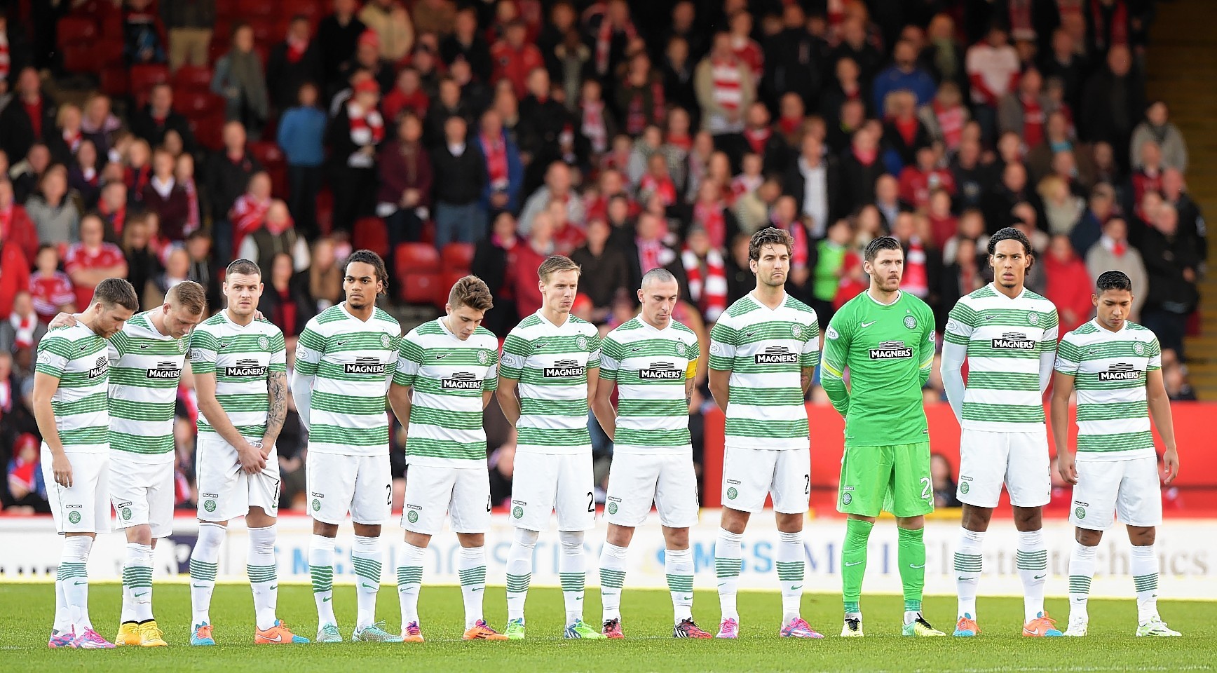 The Celtic players pay their respects prior to the match at Pittodrie.