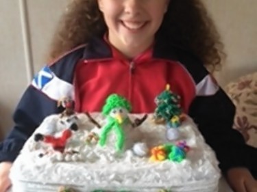 Dezzy Partington with her loom band cake