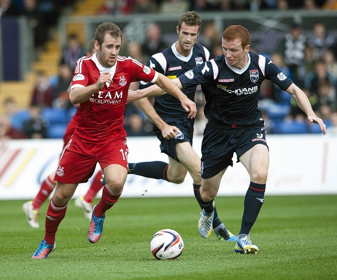 Niall McGinn and Scott Boyd lock horns