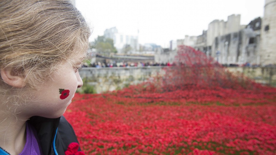 Grace Aldcoin, nine, looks at the art installation Blood Swept Lands and Seas of Red at the Tower of London