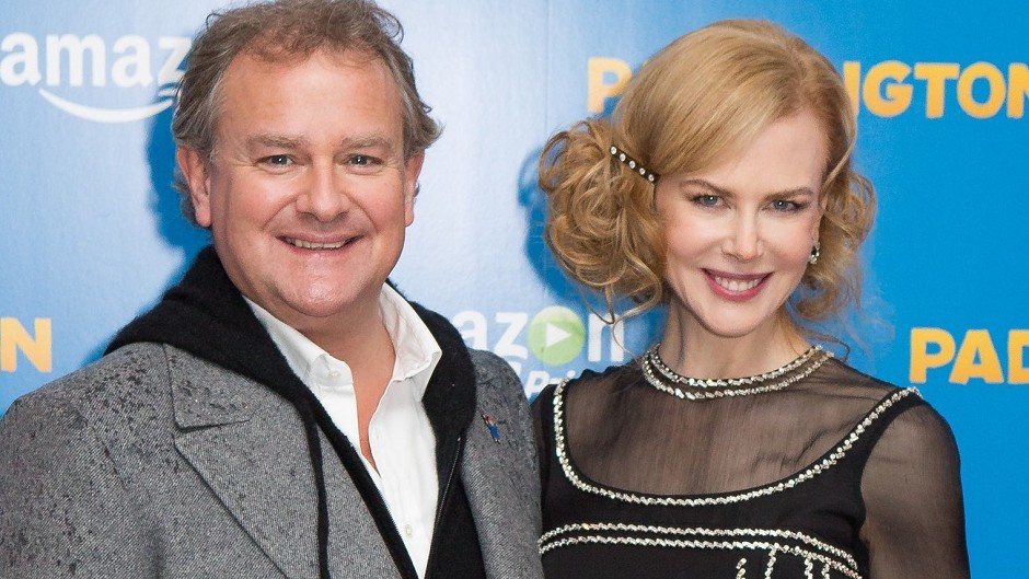 Hugh Bonneville and Nicole Kidman smile on the red carpet for Paddington. 