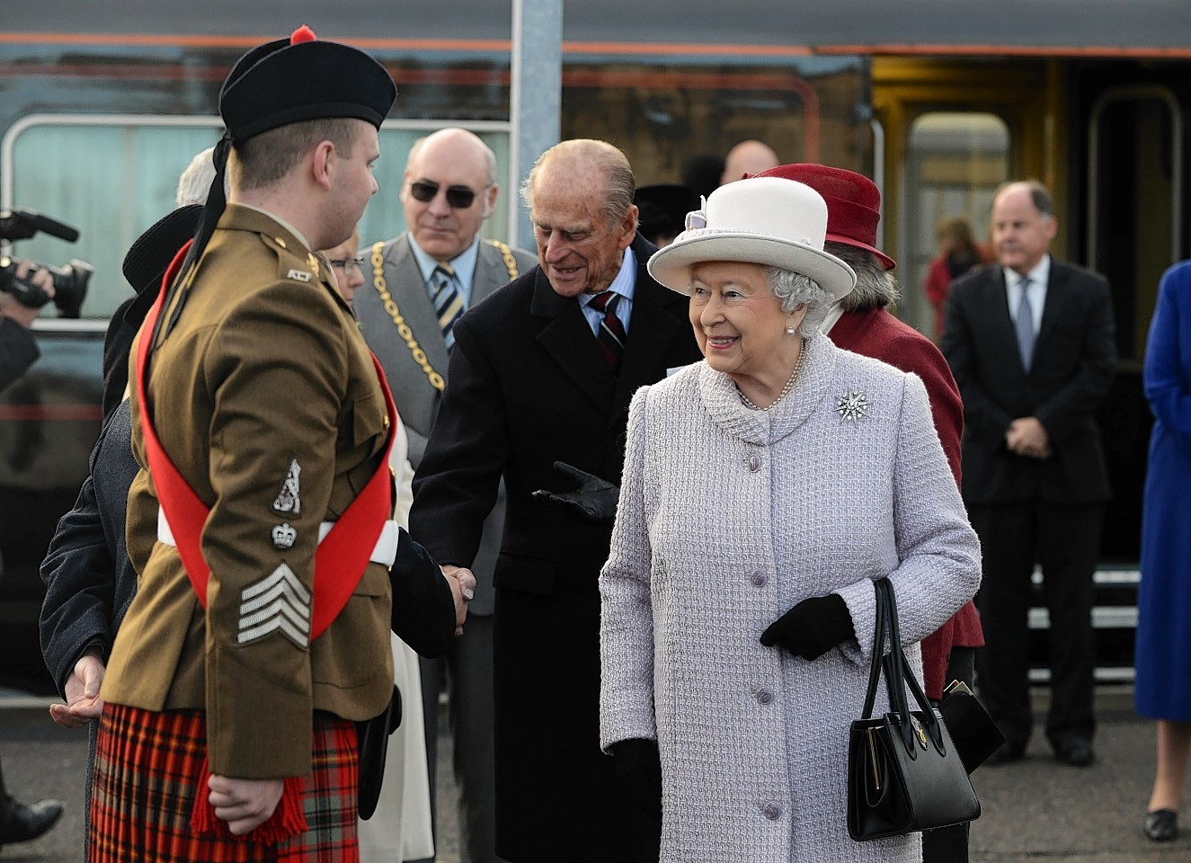 The Queen and Duke of Edinburgh meet  Pipe Major Ryan at Elgin Train Station