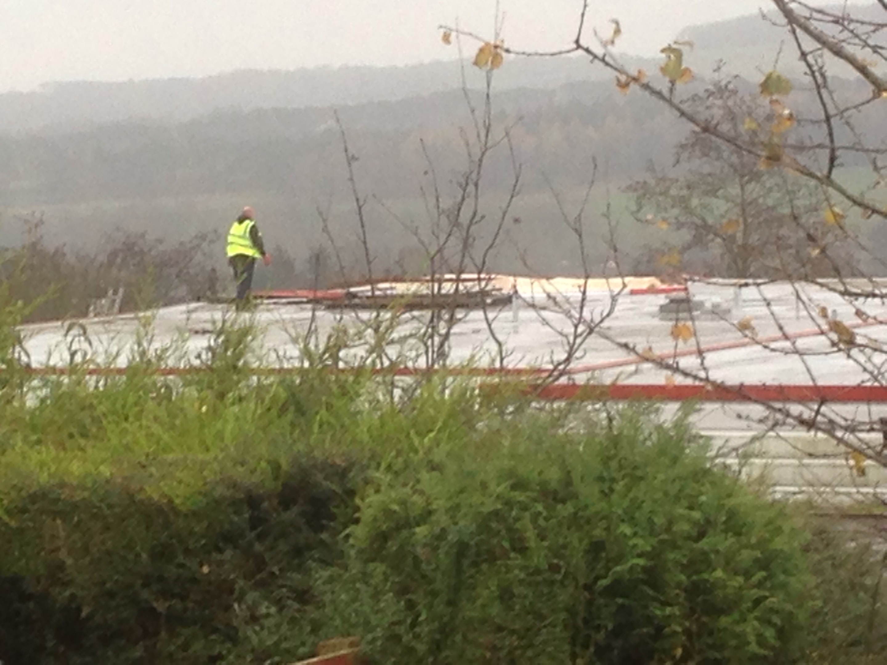 A worker on the damaged roof of Milltimber Primary School