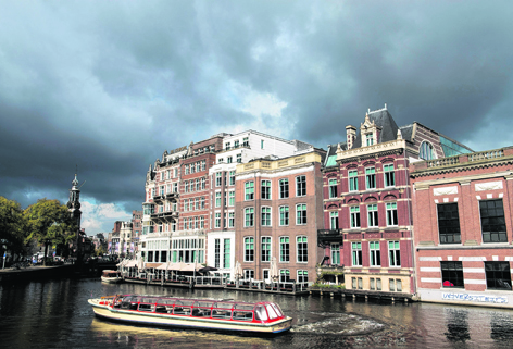 A boat rides along the canals of Amsterdam