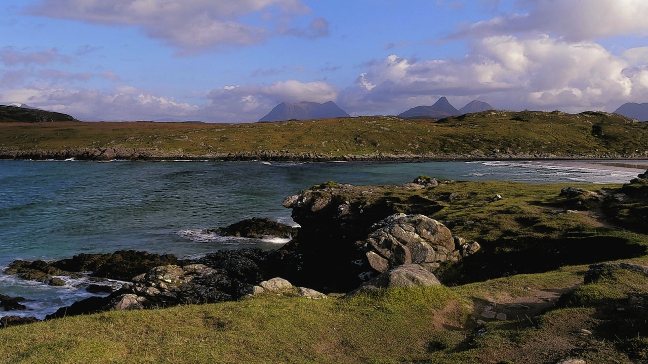 LOOKING OVER ACHNAHAIRD BAY- AN INLET ON ENARD BAY, WITH A VIEW TO THE MOUNTAINS OF THE INVERPOLLY NATURE RESERVE (INCLUDING STAC POLLY AND CUL BEAG) BEYOND, ON THE WEST COAST OF ROSS AND CROMARTY