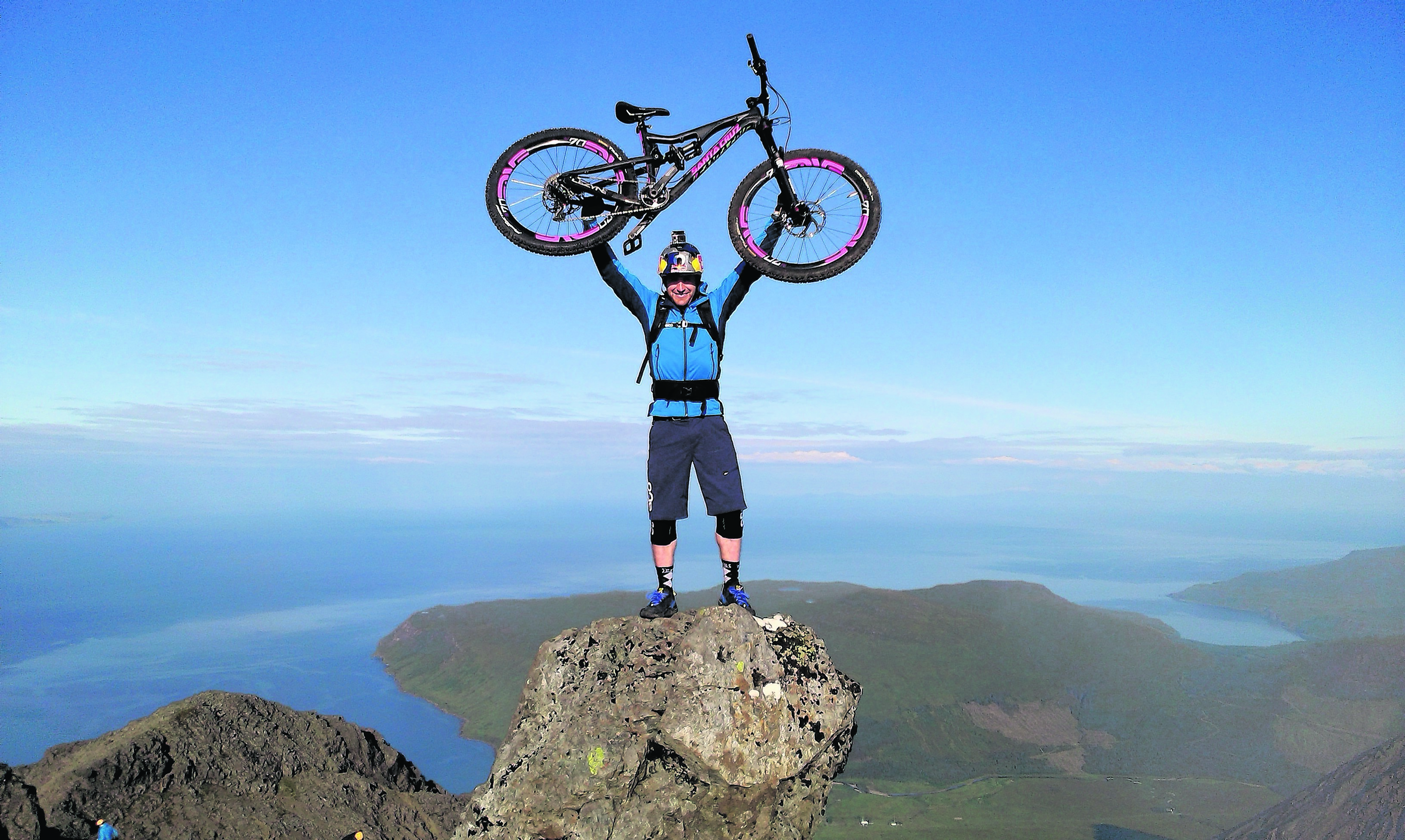 Cyclist Danny MacAskill on top of the Inaccessible Pinnacle in Skye