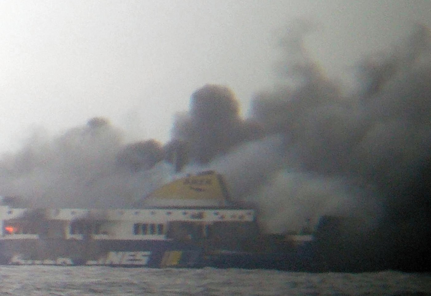 The Italian ferry, surrounded by smoke