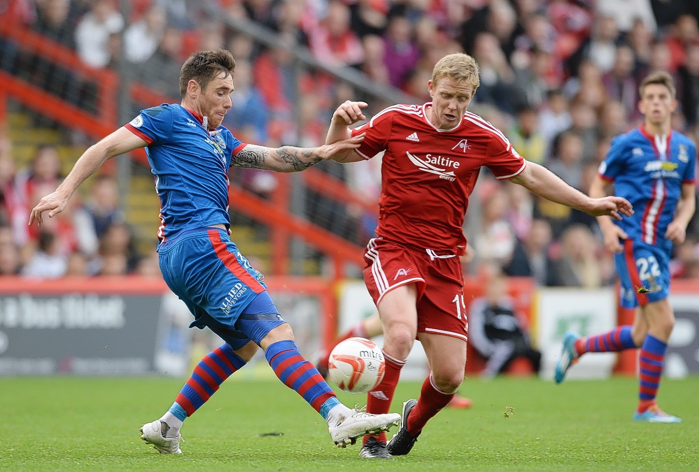 Greg Tansey and Barry Robson battle for possession 