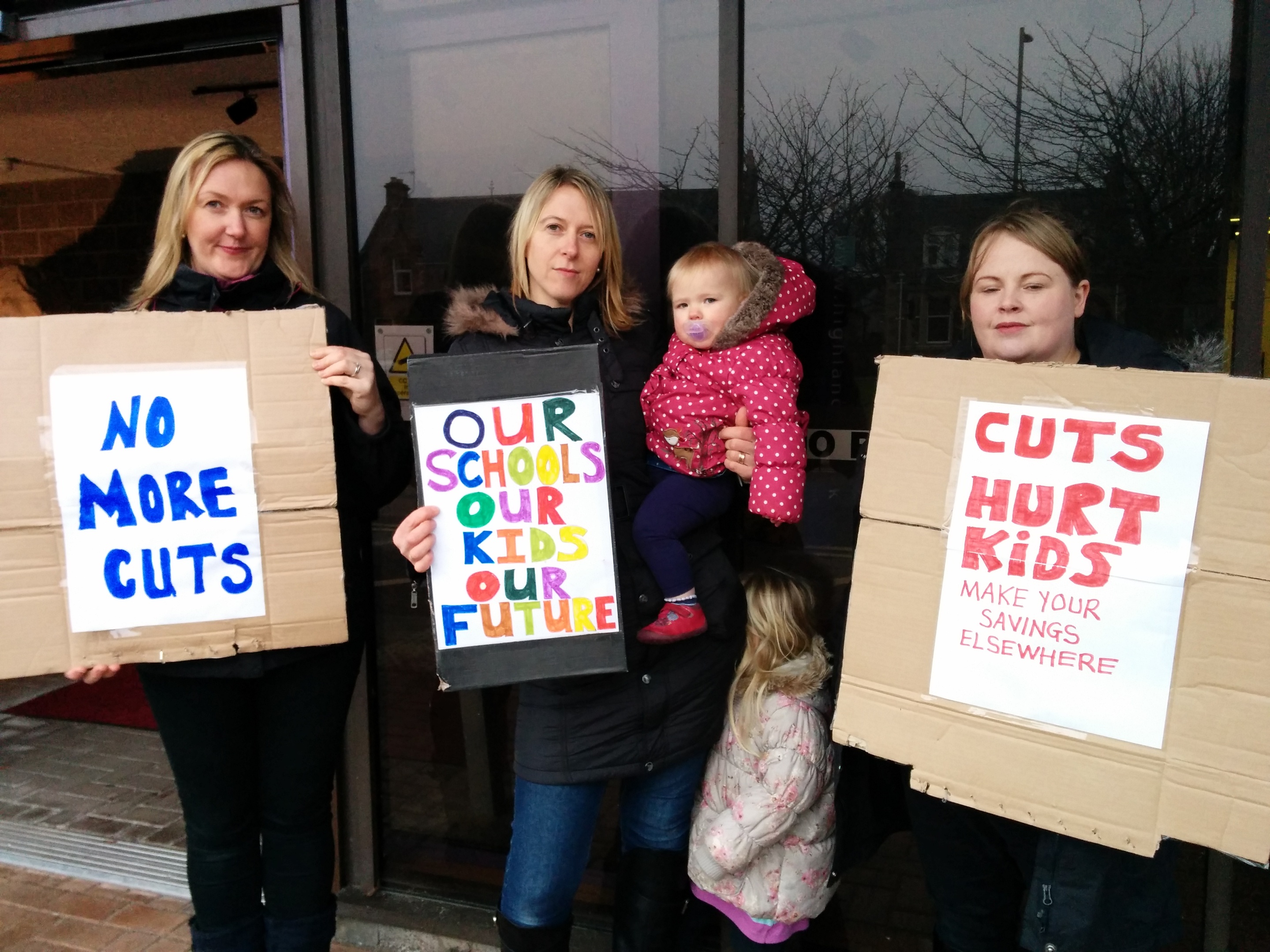 Muir of Ord mothers Tracy Underwood, Angela Budge and Natalie Shearer protest outside Highland Council's headquarters ahead of the local authority's budget meeting.