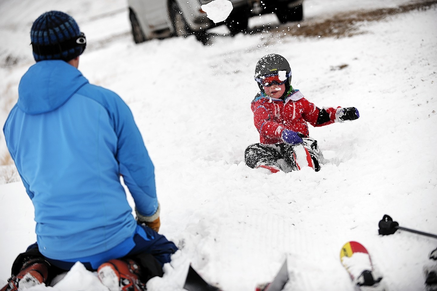 Paul Easto, takes a break from skiing at the Lecht to play in the snow with his son, Euan