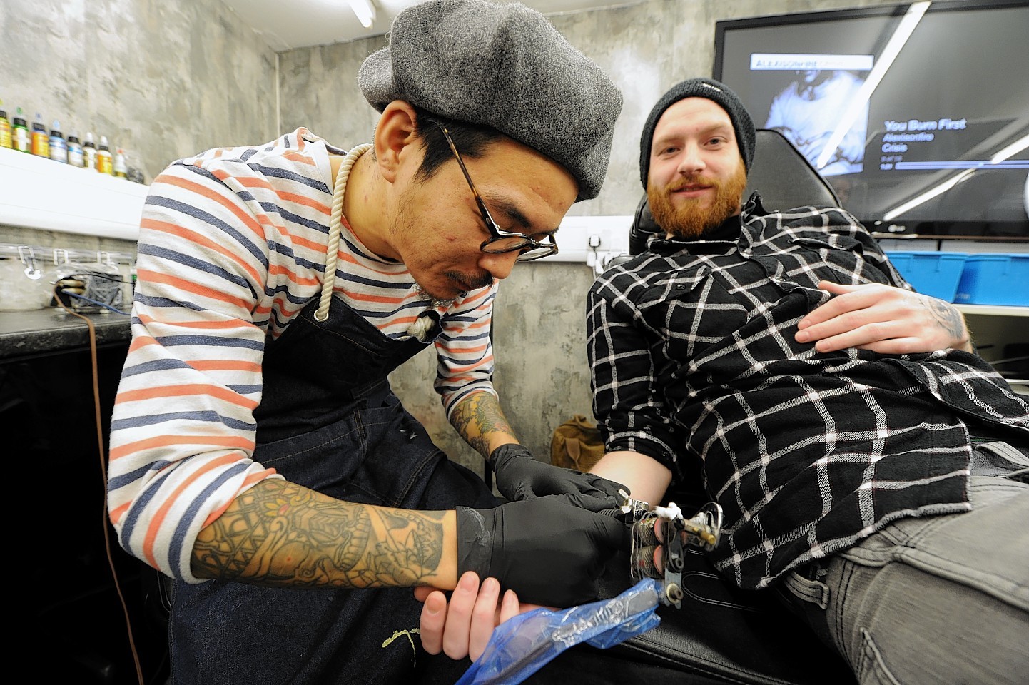 Peco with Rebel Ink owner joins Rebel Ink for a week. Photo by Jim Irvine . 