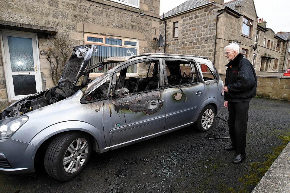 Robbie McNab inspects the damage after the car fire