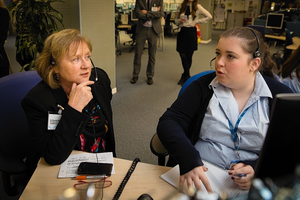 Pubic Health Minister Maureen Watt talks to frontline staff on visit to NHS 24 contact centre in Clydebank.