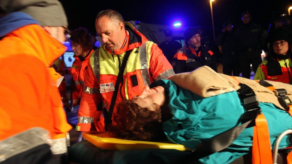 A woman is carried by paramedics as passengers of the ferry are transported to the town of Otranto, near Lecce, southern Italy (AP)