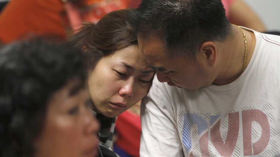 A relative of the passengers of AirAsia flight QZ8501 weeps as she waits for the latest news on the missing plane (AP)